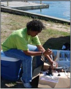 Dr. Croxton setting up a field experiment on the edge of Milford Harbor.